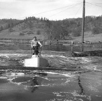 Moving logs on logpond with boat