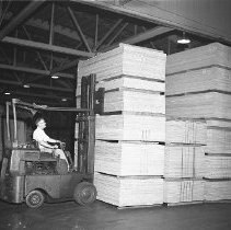 Stacking plywood in mill