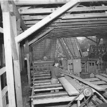 Sawmill workers edging lumber