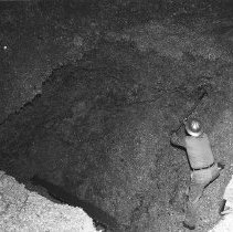 Mill worker shifting chip pile