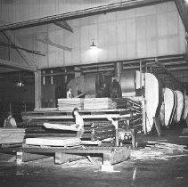 Mill workers moving plywood