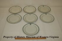 Seven white china plates