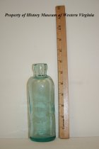 Glass bottle with a light blue tint.