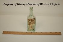 Green glass medicine bottle containing "hot drops."