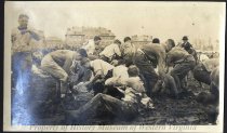 Young men wrestling in mud