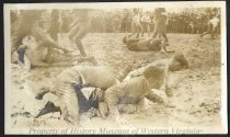 Young men wrestling in mud