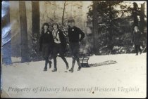 Two women and man with sled