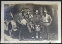Four men in front of a Cornell car