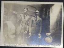Three men in front of Cornell car