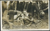 Young men wrestling in mud