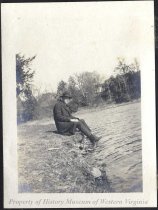 Man sitting by a river