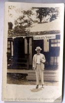 Man in front of Charlie's Shanty, front