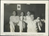 Four men (at Red Cross?)
