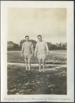 Two men in a muddy field