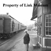 Individuals Standing, Watching Train 202 Leave Lansing