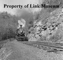 Engine 382, Train No. 201 Appearing Behind A Rock Out Cropping