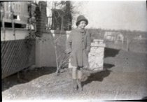 Woman Standing Next to House