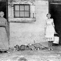 Susan and Lizzie Landis feeding cats, ca. 1905