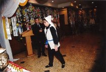 A woman in white approaching the altar for Shuying Wong-Chen