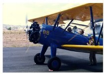 Maggie Gee in the cockpit of a biplane