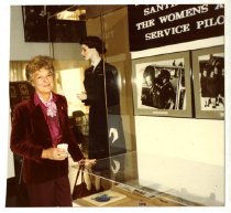 A woman in front of an exhibition full of WASP memorabilia