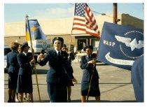 A group of WASP holding flags