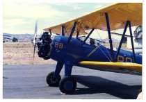 Maggie Gee is sitting in the cockpit of a biplane