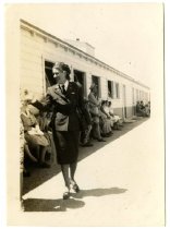 Jaqueline Cochran walking past a building