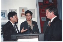 Three men around podium