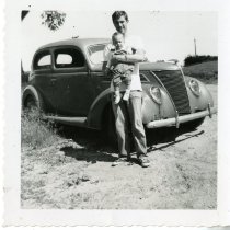 Charles Kelly with son in front of car