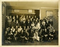 Psi Omega fraternity and women in living room, 5/3/1919