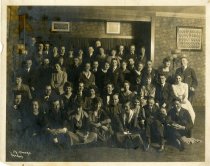 Psi Omega fraternity and women in living room ca. 1919