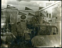 Photograph of two men smoking pipes in dorm room ca. 1914-1917