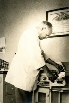 Photo of dentist [Charles Perce Stone] operating sterilizer