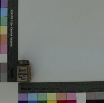 Small Detroit alloy bottle with silver-toned lid and gray and red labels