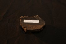 Small fragment of a clay pottery with a textured pattern