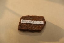 Small fragment of a clay pottery with a painted surface