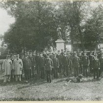 Civil War monument with firemen's group posed in front