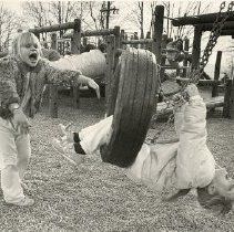 Shannon Gilstad and Caitlin Calcagnini playing on a tire swing at Pequenakonk Elementary School