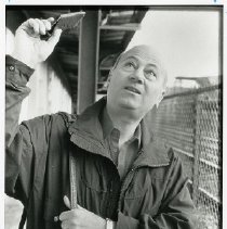 Fred Gill points to new roof above platform at Yonkers train station
