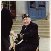 Member of Leonard Morange American Legion Post 464 seated outside Bronxville School prior to a parade