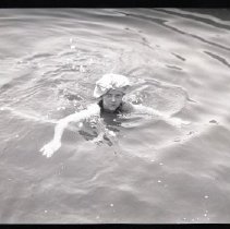 Unidentified member of the Iselin family swimming at Breakwater House