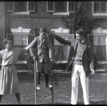Members of the Iselin family playing with stilts at Breakwater House