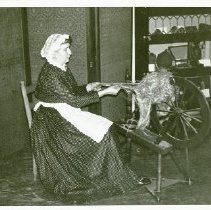 Evelyn Hodecker Hunt (Mrs. Elliot Baldwin Hunt) at a spinning wheel