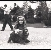 Unidentified girl (member of the Iselin family) with a dog