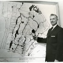 Chief Marvin F. Ericson of the Westchester County Parkway Police in front of a map of Westchester parkways