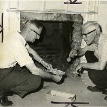 William F. Dornbusch (left), president of the Rye Historical Society, and Daniel M.C. Hopping, architectural historian, looking through debris at a fireplace in the Square House