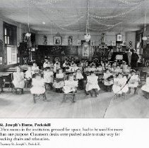 Small children in rocking chairs in classroom, St. Joseph's