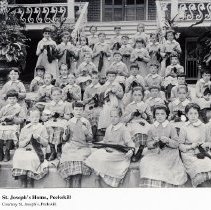 St. Joseph's Home, girls in uniforms sitting on steps, all knitting