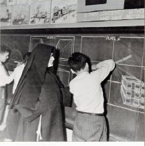 Teacher with child at blackboard, St. Joseph's Orphanage